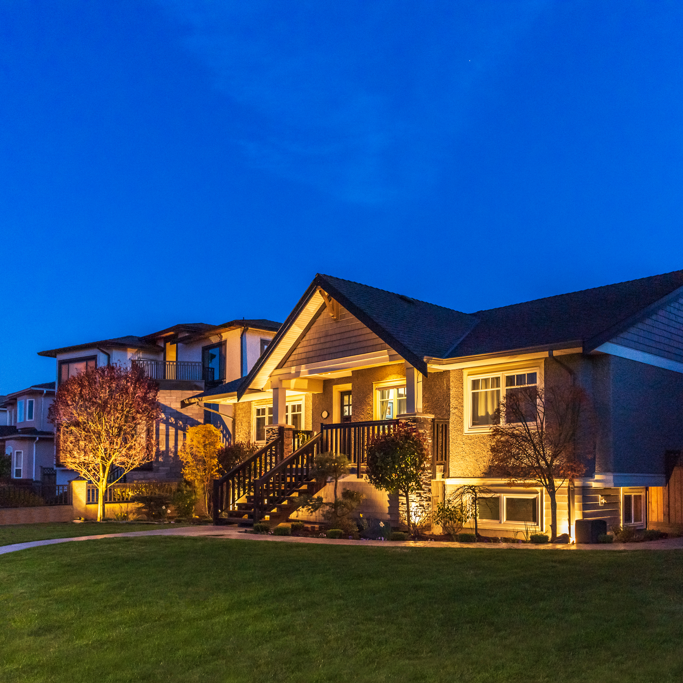 back of home with landscape lighting