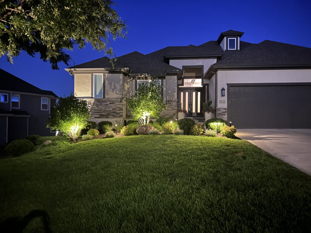 house at night with landscape lighting